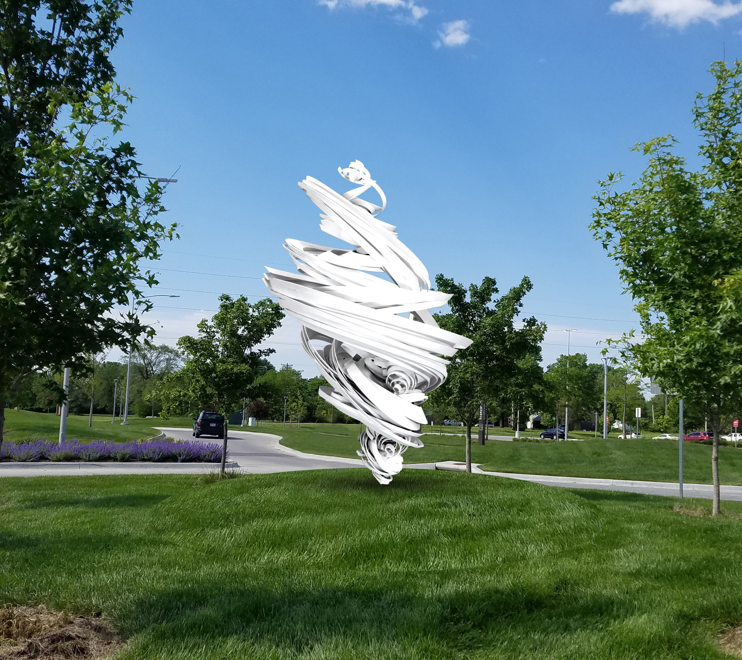 A white swirling metal sculpture in green grass