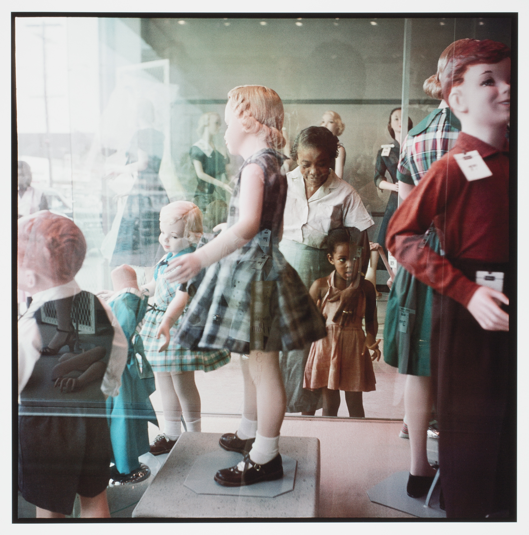 A group of people standing in front of a store