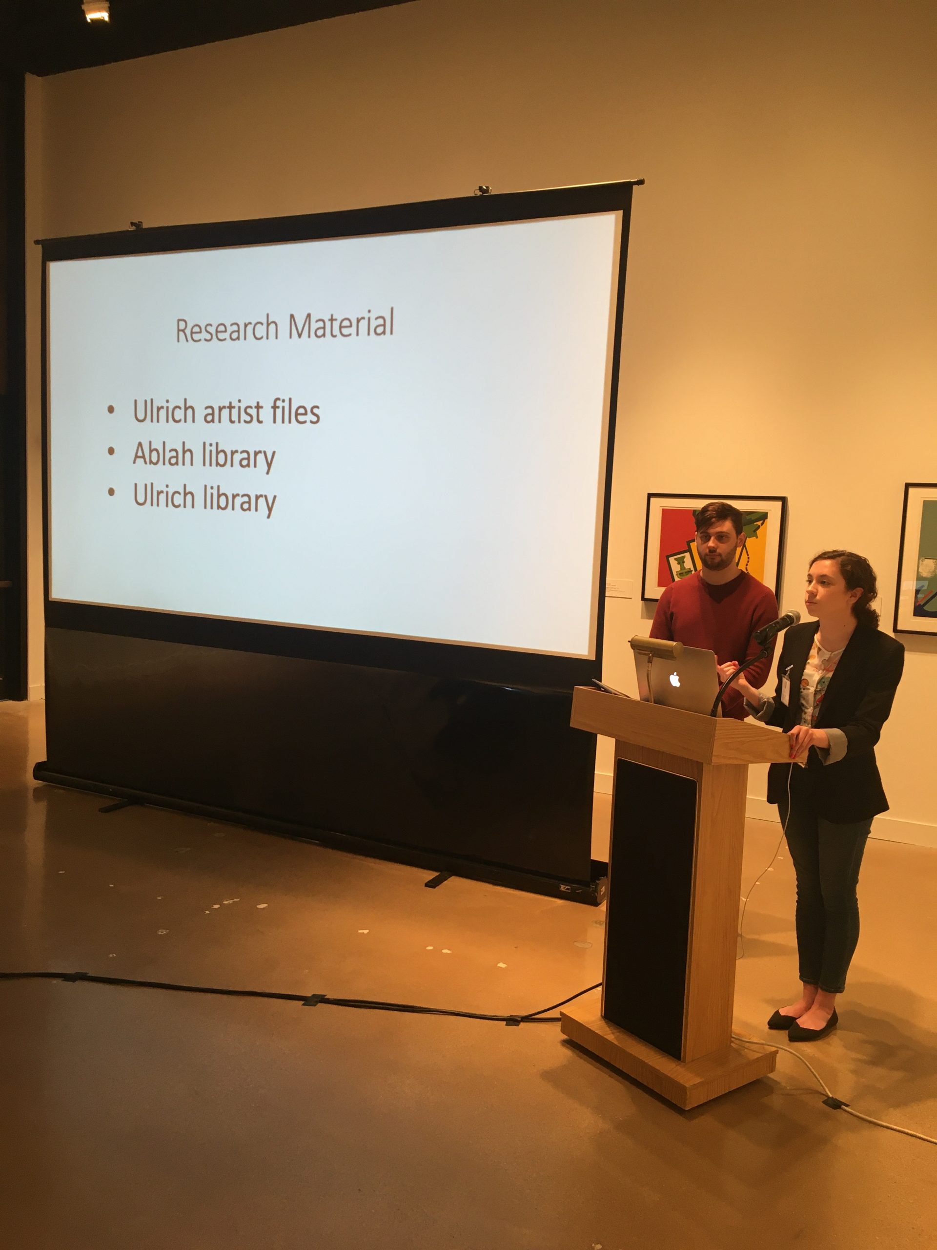Two interns stand at a podium