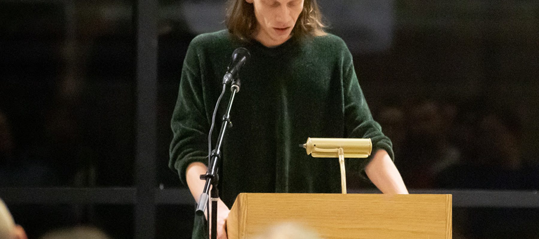 A person standing in front of a microphone