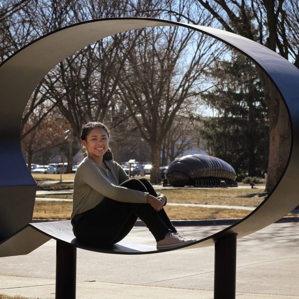 Journi Brown sits inside an outdoor sculpture