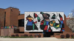 The front of the Ulrich Museum is pictured with a large, glass mural, Personnage Oiseaux, by Joan Miro.