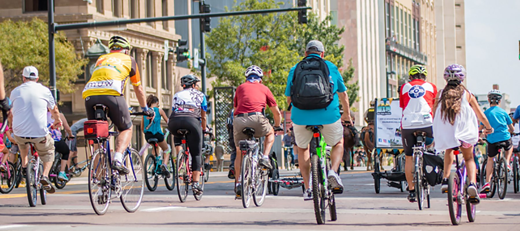 A group of bike riders ride down Douglas Avenue in Wichita.