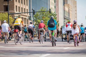 A group of bike riders ride down Douglas Avenue in Wichita.