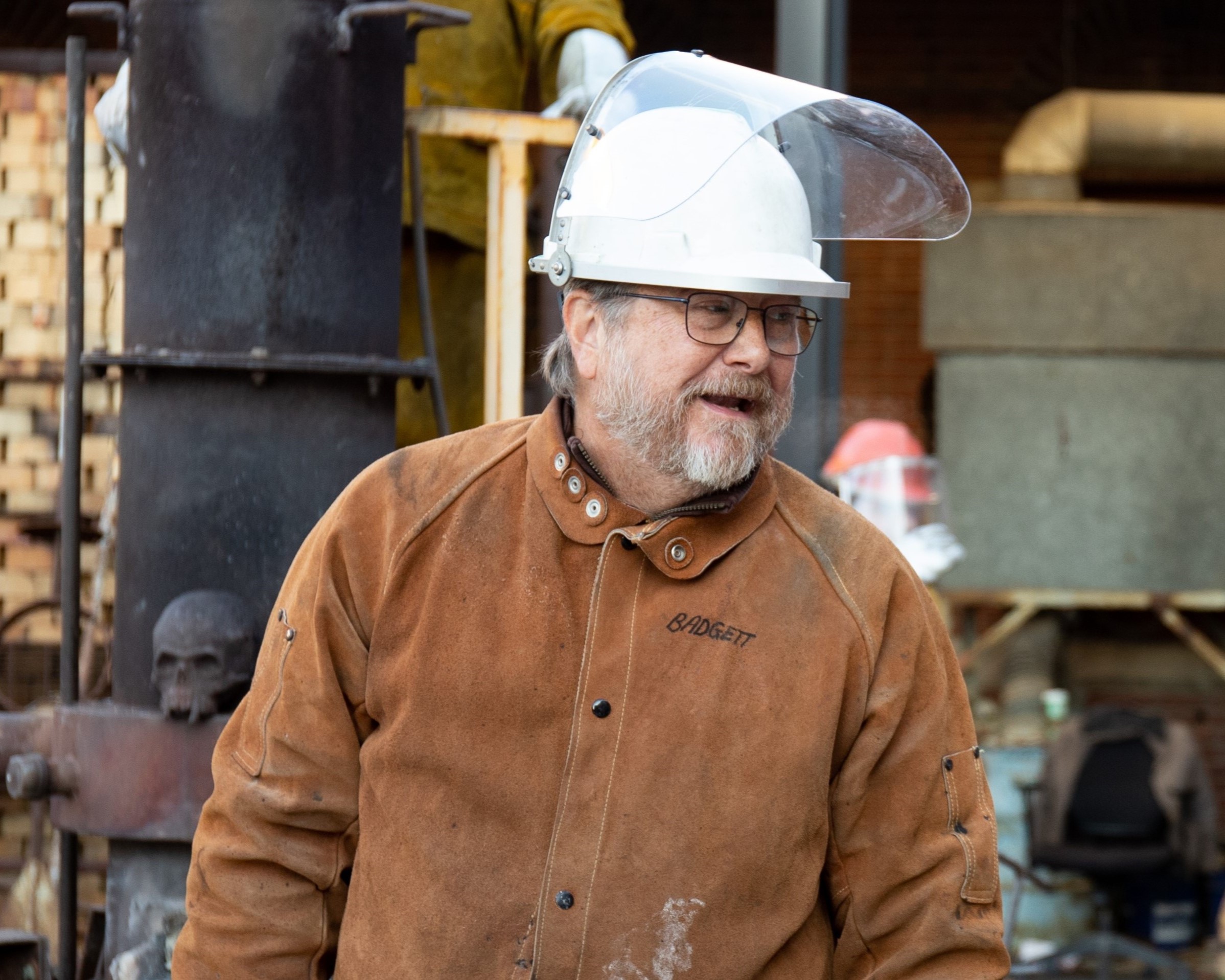 Instructor Barry Badgett, dressed in a suede protective jumpsuit, talks to students.