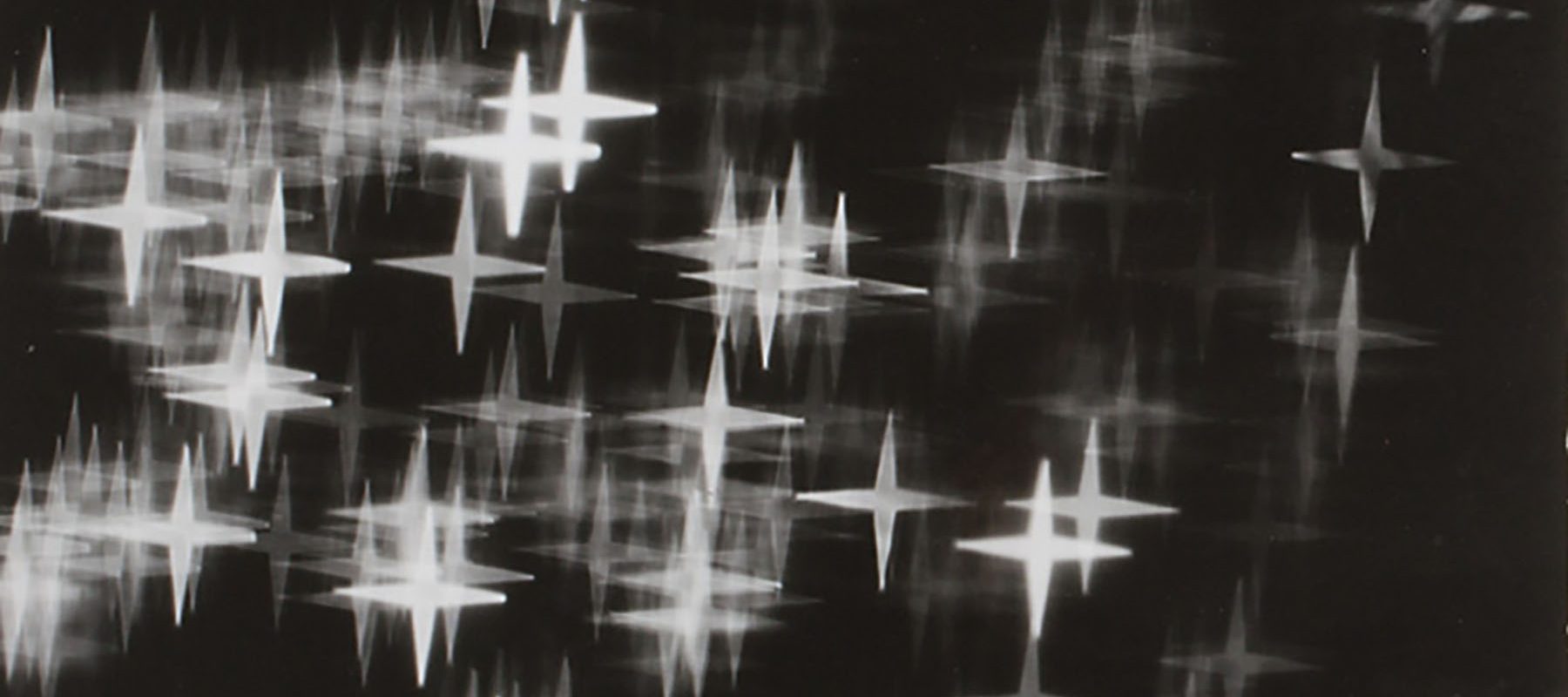 White and gray star shapes on a black background.