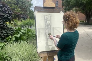 Artist Rachel Curtis draws outdoors using an easil