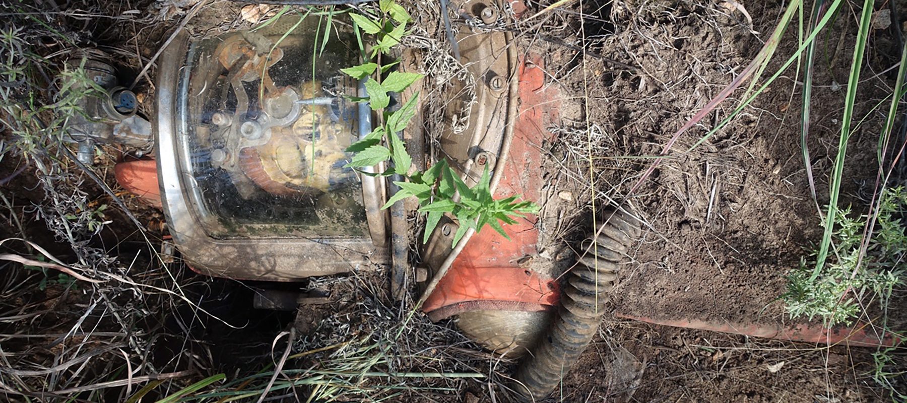 A fake astronaut is buried in the ground.