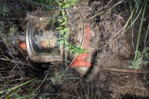 A fake astronaut is buried in the ground.