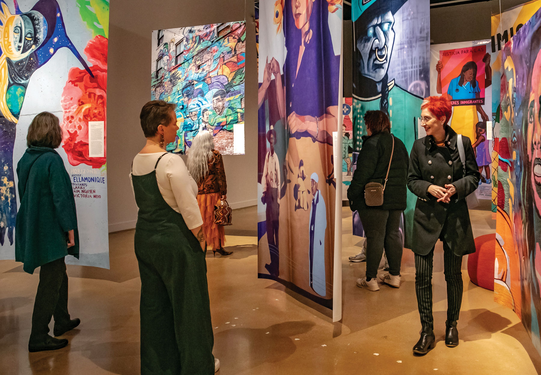 visitors examine modern art tapestries in an ulrich gallery