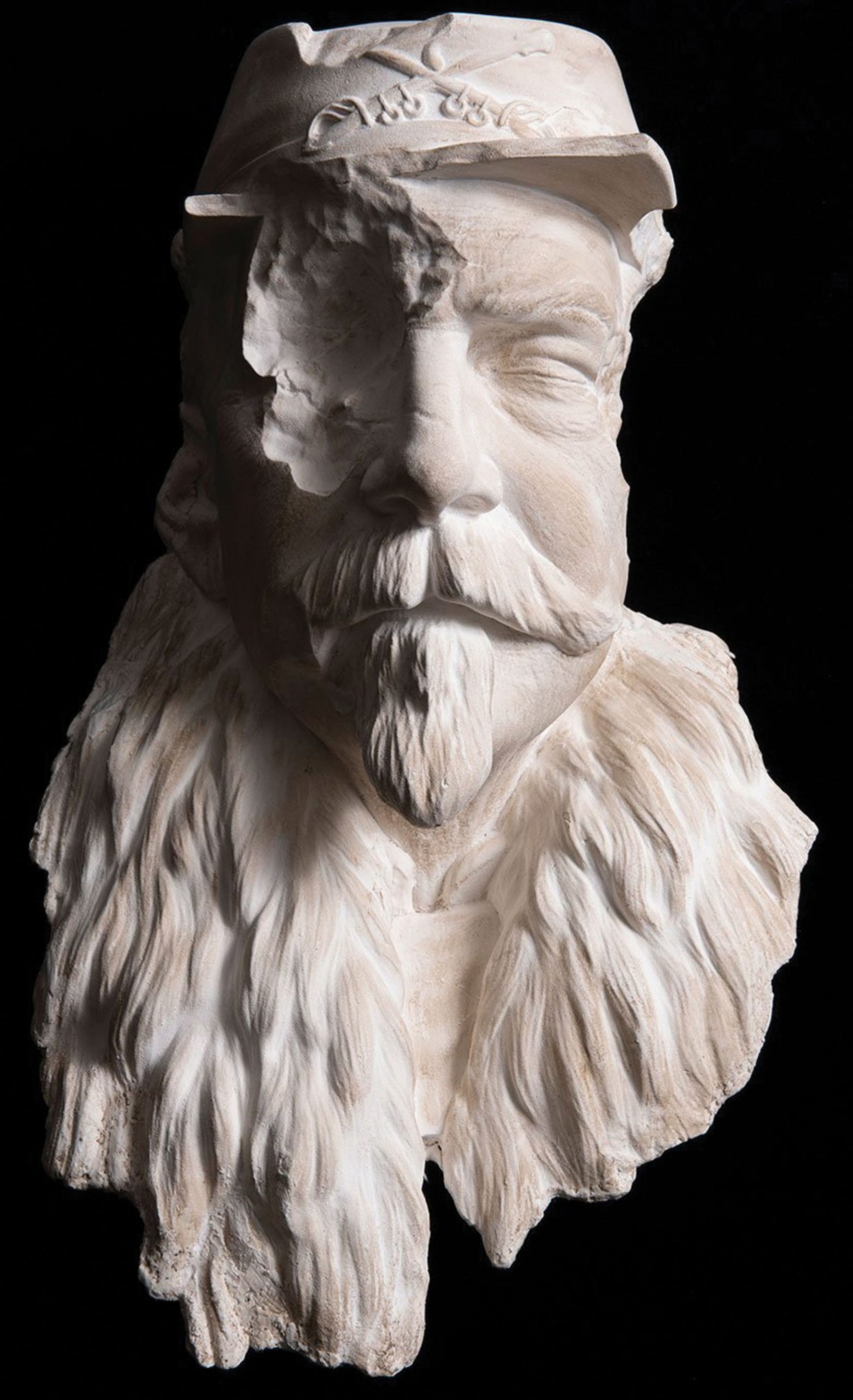 Plaster sculpture of a bearded civil-war-era solider with a chunk missing where his right eye should be