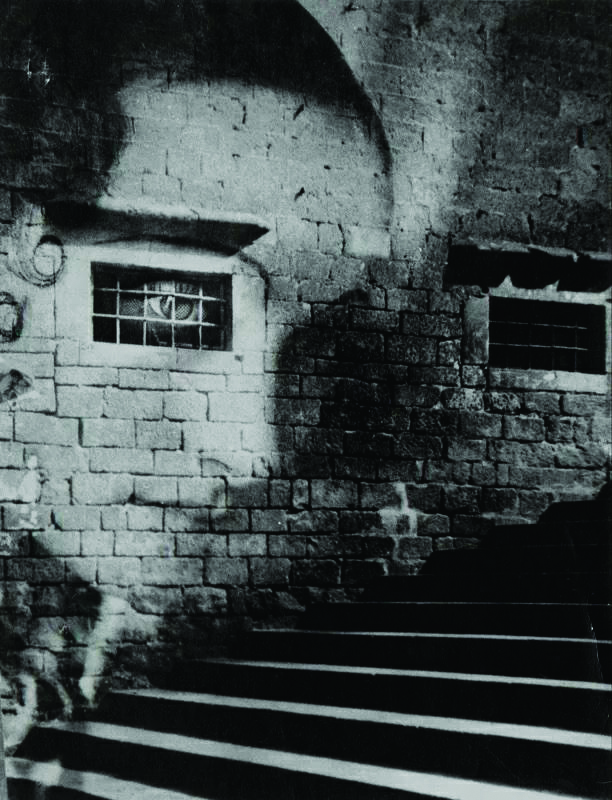 a 1930s womans face superimposed on a brick wall with staircase