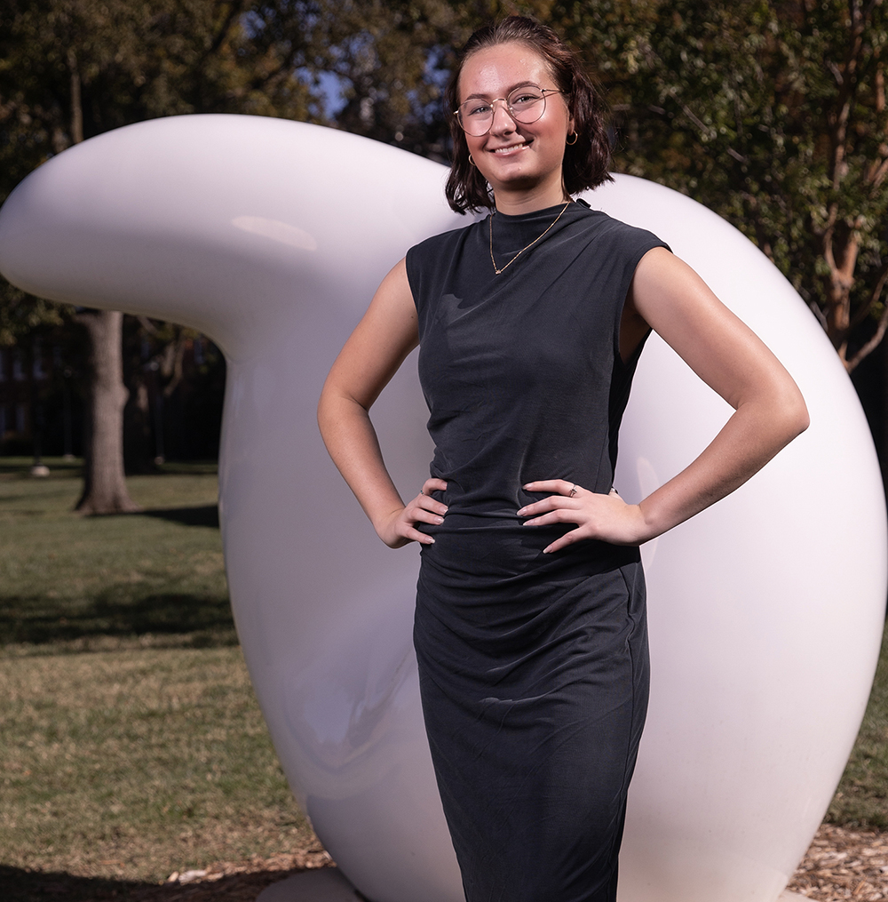 Maddie Bowron stands in front of a rounded white sculpture.