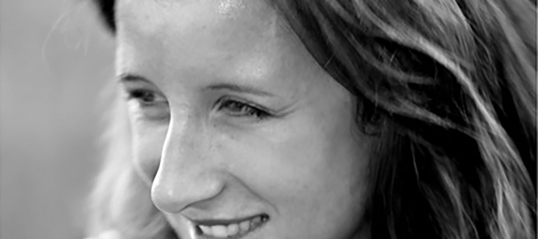 A close up black and white photo of a woman.