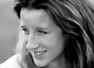 A close up black and white photo of a woman.