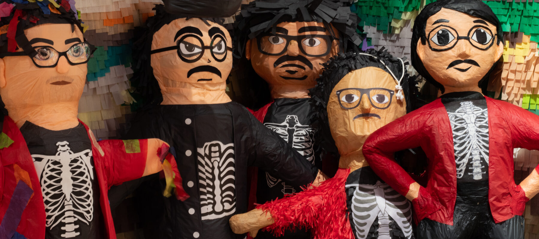 Piñatas in a row, all look like artist Justin Favela.