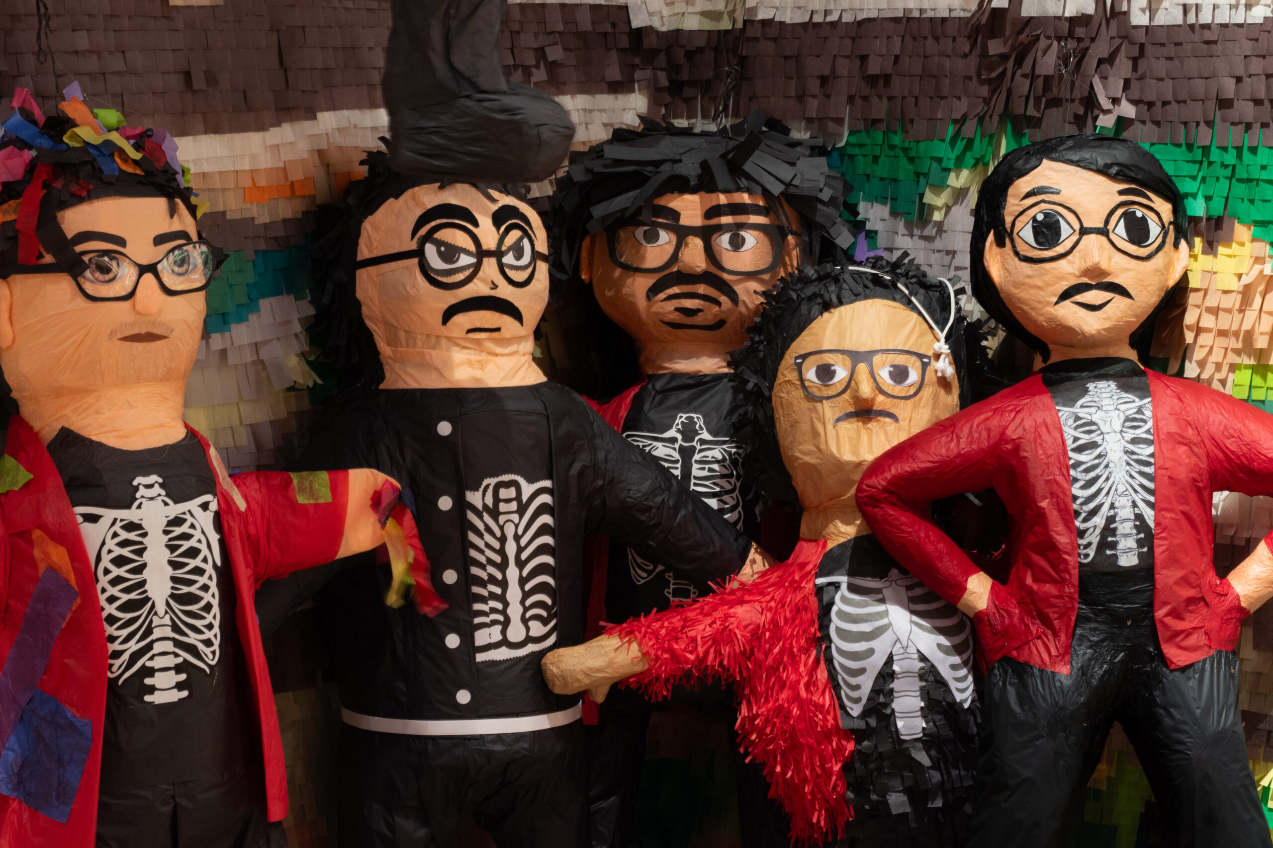 Piñatas in a row, all look like artist Justin Favela.