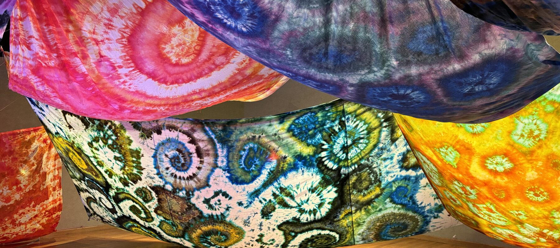 Colorful fabric is draped from the ceiling and inflated with a fan.