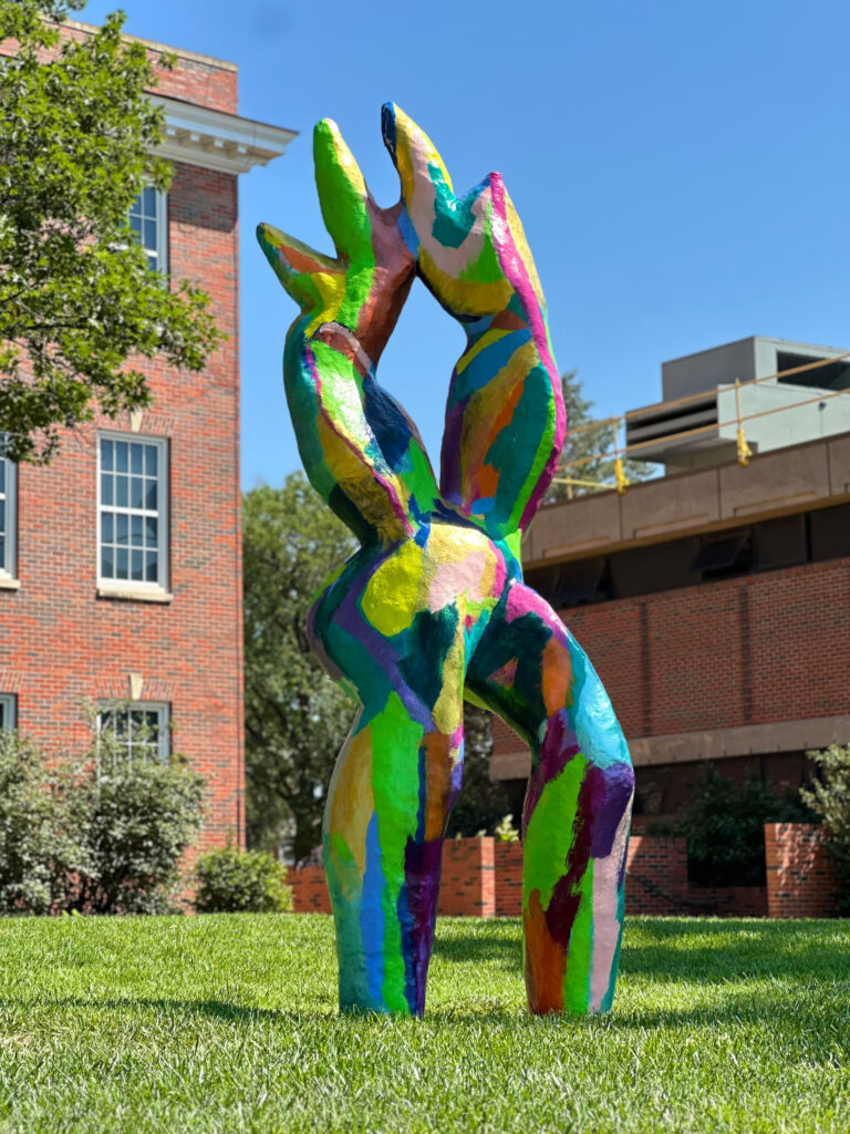 A colorful large sculpture that resembles a human body.