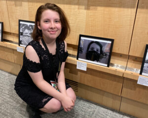 A student poses with her award-winning photograph.