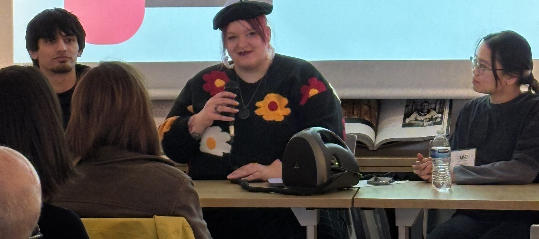 Students presenting a program in from of a screen.