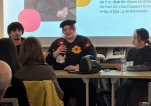 Students presenting a program in from of a screen.